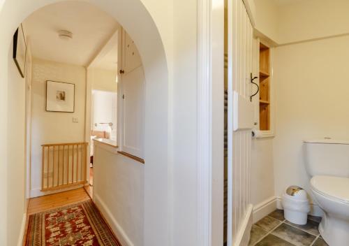 a bathroom with a toilet and a sink at Wayfarer Cottage in Woodbridge