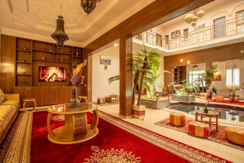 a living room with a couch and a table at Riad Kenza in Marrakech