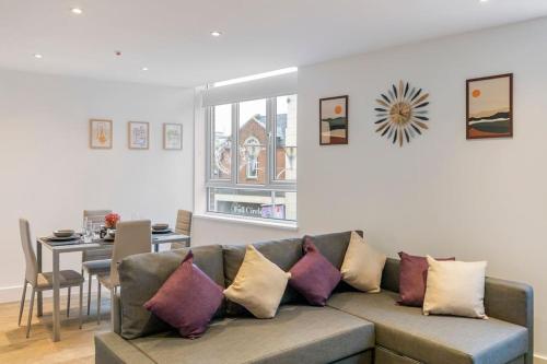 a living room with a couch and a dining room at Chelmsford Centre View Sleep 4 Next Chelmer canal in Chelmsford