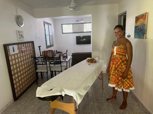 a woman standing next to a hospital bed at Tartane beach spa in La Trinité