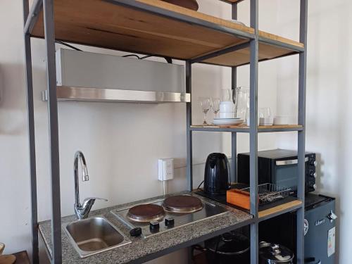 a small kitchen with a sink and a counter top at Apartamentos Cerro Alegre in Valparaíso