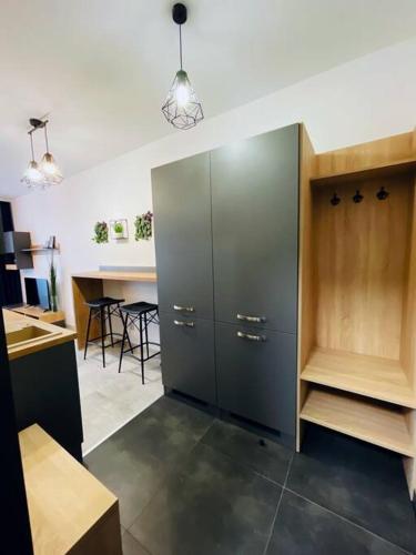 a kitchen with a large cabinet and a table at Apartmán Twins Blue blízko centra in Michalovce