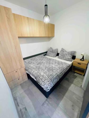 a bedroom with a bed and a wooden cabinet at Apartmán Twins Blue blízko centra in Michalovce