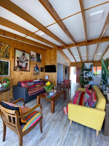 a living room with couches and a tv at Casa Tongoy Península in Coquimbo