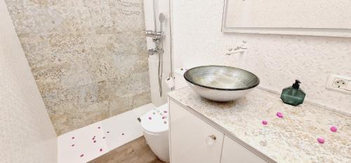 a bathroom with a sink and a bowl on a counter at Luxury ocean view 1 bedroom in Playa de las Americas
