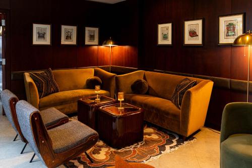 a living room with a couch and a table and chairs at Library Hotel by Library Hotel Collection in New York