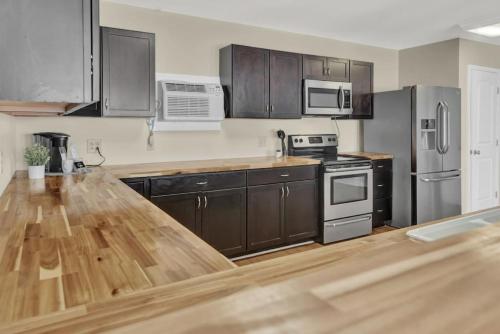 a kitchen with wooden counter tops and stainless steel appliances at Bahama Breeze Suites in Panama City Beach