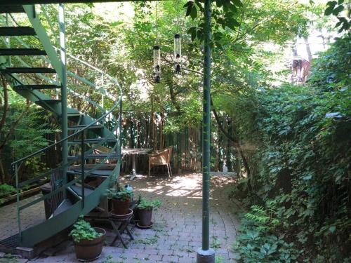 un patio avec une table et un escalier orné de plantes dans l'établissement Quiet cozy apartment with A/C, backyard, Netflix, à Montréal