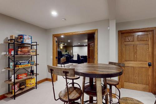 a dining room with a table and some chairs at High Country Pool House in Sturgis