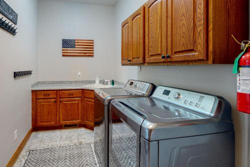 a laundry room with a washer and a sink at High Country Pool House in Sturgis