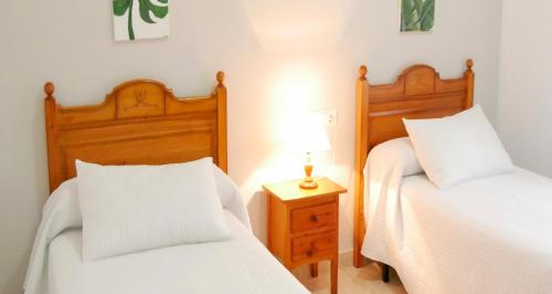 Ένα ή περισσότερα κρεβάτια σε δωμάτιο στο Hostal Al-Andalus