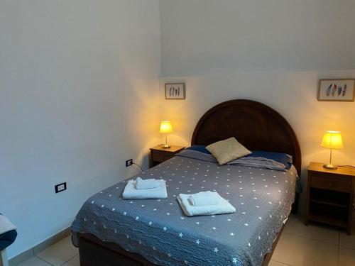 a bedroom with a bed with two towels on it at Lince Apartments in Lima