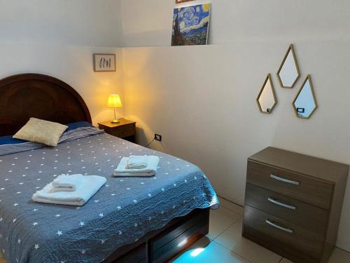 a bedroom with a bed with two towels on it at Lince Apartments in Lima