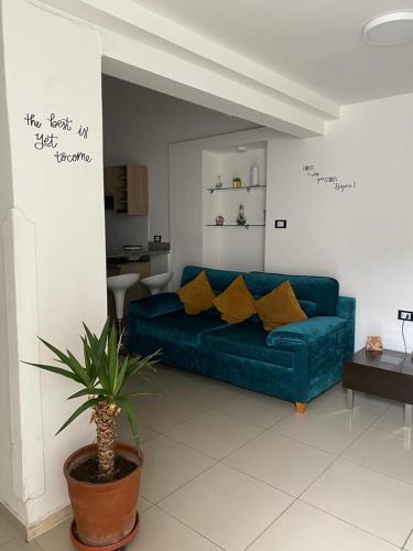 a living room with a blue couch with yellow pillows at Lince Apartments in Lima