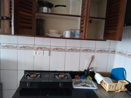 a kitchen with a stove and a counter top at Galene Abode Studio Apartment, Nyali in Mombasa