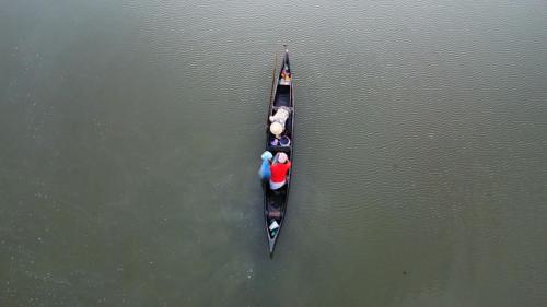 a group of people in a canoe in the water at Bachan's Casa in Cherai Beach