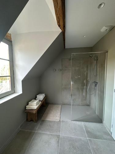 a attic bathroom with a shower and a staircase at Jolie grange rénovée. in Couches