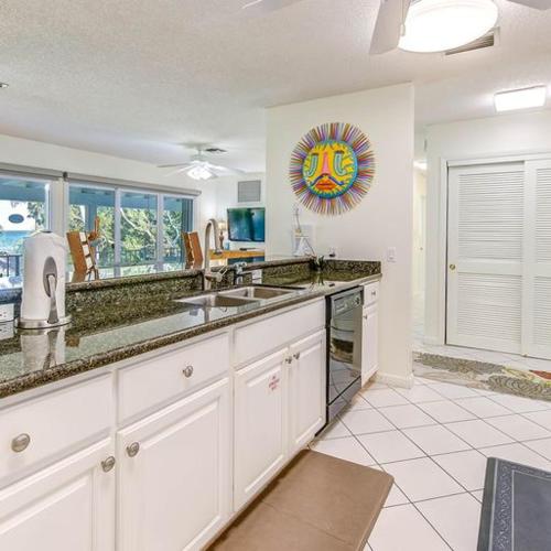 a kitchen with white cabinets and a counter top at Little Bay Compound in Islamorada