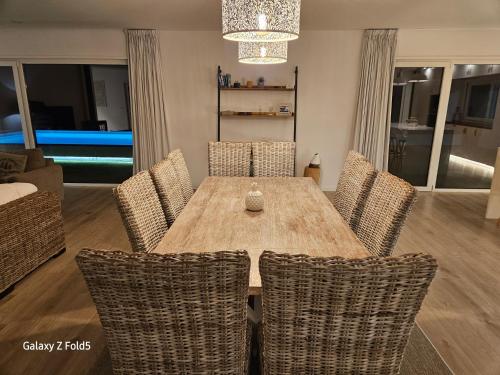 a dining room with a wooden table and chairs at One of a Kind #PDL Luxury Retreat in Ponta Delgada