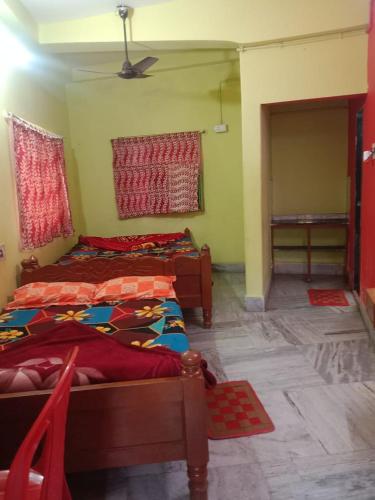 a room with two beds in a room at PAYEL LODGE in Digha