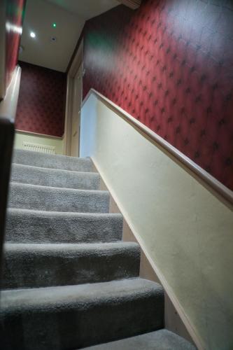a set of stairs in an auditorium with a red wall at the kingsbury 7even 8ight in Marlborough