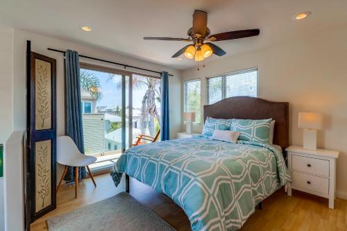 a bedroom with a bed and a ceiling fan at Beach Oasis - Rooftop, Steps2Sand and Water Views in San Diego