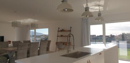 a kitchen with a sink and a large window at One of a Kind #PDL Luxury Retreat in Ponta Delgada
