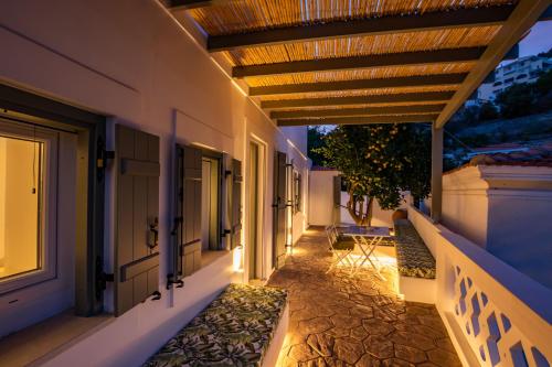 a hallway of a house with awnings and a walkway at Valandou Guesthouses in Karpathos Town