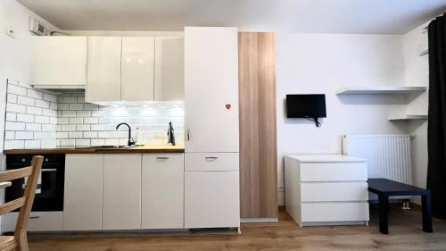 a kitchen with white cabinets and a sink at Downtown Apartment 2 in Krakow