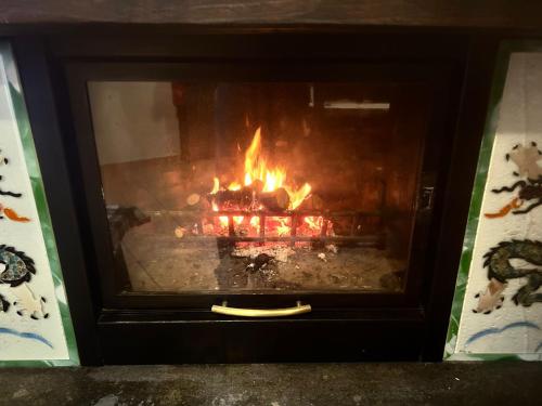 a fireplace with a fire in it at Country house Dolce Nocciola in Vignanello