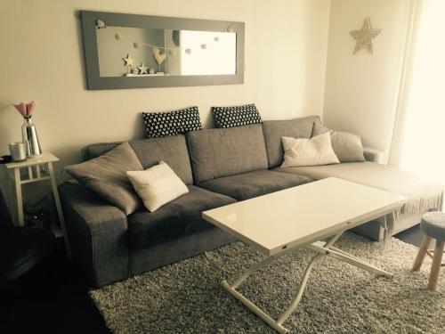 a living room with a couch and a table at Beautiful house 10 minutes to Paris in Drancy