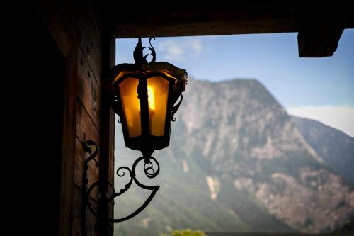 a light hanging from a building with a mountain in the background at Villa22 Oetz in Oetz