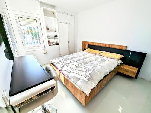 a bedroom with a bed and a tv in it at CHALET CALAFAT in Calafat