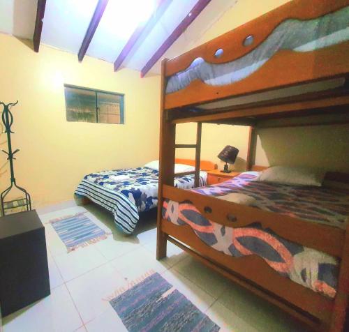 a bedroom with two bunk beds in a room at Ttikay Wasi in Cusco
