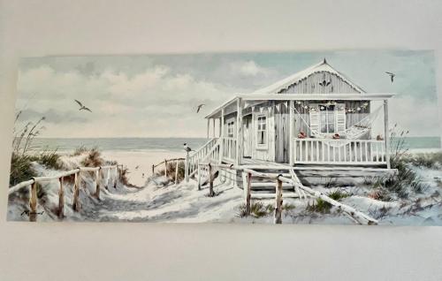 un dipinto di una casa sulla spiaggia nella sabbia di The Coastal Escape a Bournemouth