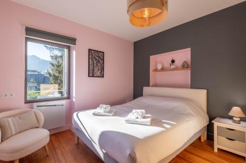 a bedroom with a bed and a chair and a window at Villa des Cygnes près du lac marina Grand Port in Aix-les-Bains