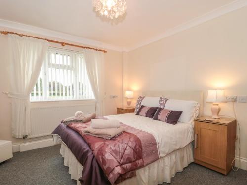 a bedroom with a large bed and a window at Russet in Bridgwater