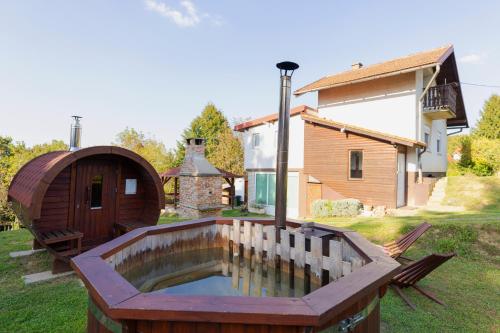 a hot tub in a yard next to a house at Kuća za odmor Activ in Sveti Ilija