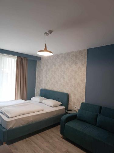 a bedroom with a bed and a couch at new Gudauri 214 in Gudauri