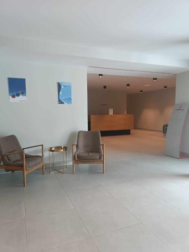 a waiting room with two chairs and a table at new Gudauri 214 in Gudauri