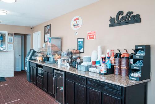 a kitchen with a counter top with a coffeeacist at Super 8 by Wyndham Columbia/Ft. Jackson SC in Columbia