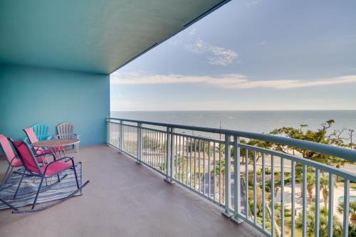 a balcony with chairs and a table and the ocean at Gulfport Condo with Views Walk to Beach in Gulfport