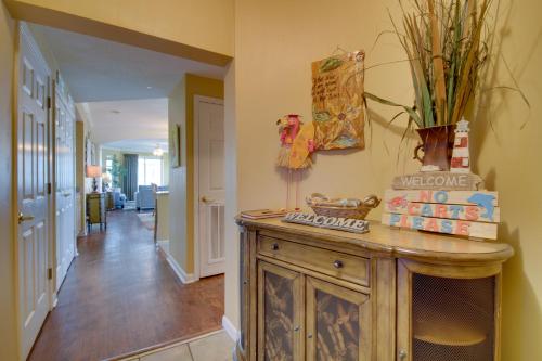 a hallway with a wooden cabinet in a house at Gulfport Condo with Views Walk to Beach in Gulfport