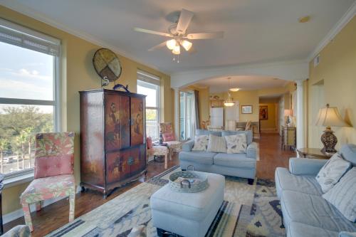a living room with furniture and a ceiling fan at Gulfport Condo with Views Walk to Beach in Gulfport
