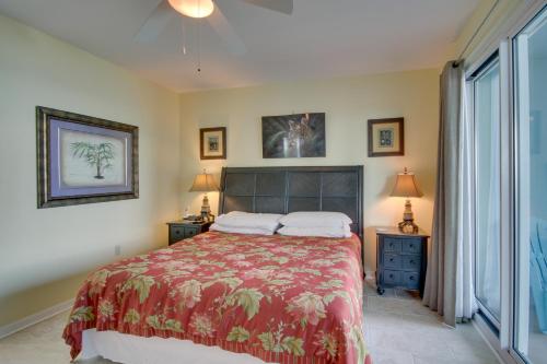 a bedroom with a bed with a red bedspread at Gulfport Condo with Views Walk to Beach in Gulfport