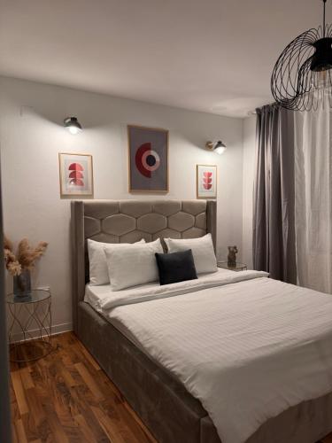 a bedroom with a large bed with white sheets at Skido in Braşov
