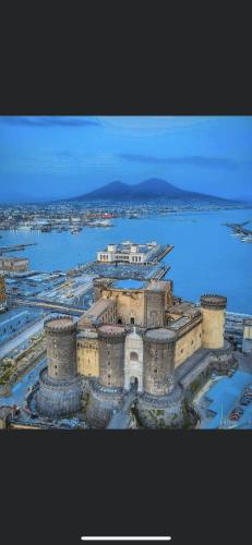 an aerial view of a building with water and a city at Il Rifugio Dei Partenopei in Naples
