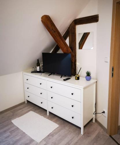 a white dresser with a tv on top of it at ubytování U NIKY in Hodonín