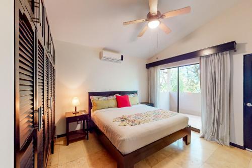a bedroom with a bed and a ceiling fan at The Cove #16 in Ocotal