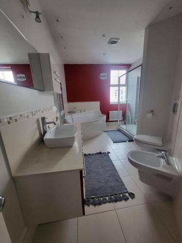 a bathroom with two sinks and a toilet at Haya Guest House in Birmingham